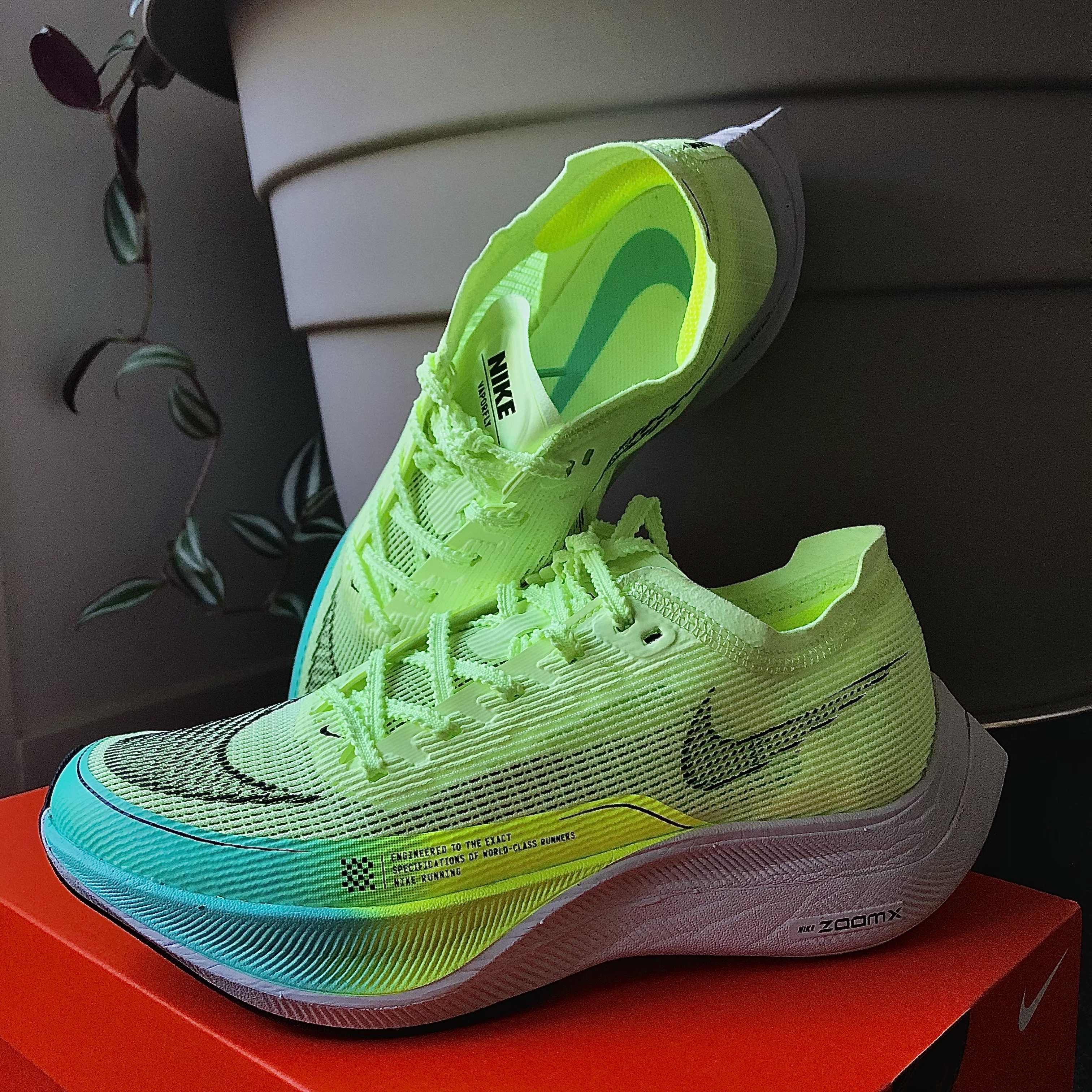 Brightly coloured yellow and blue Nike vaporfly cabon plated running shoes